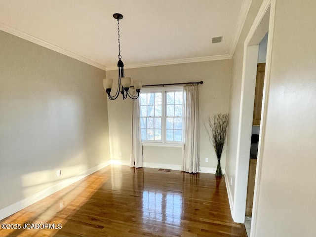 unfurnished dining area featuring crown molding, dark wood-type flooring, and an inviting chandelier