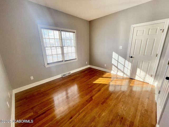 spare room featuring dark wood-type flooring