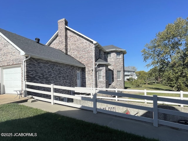 view of side of home featuring a garage