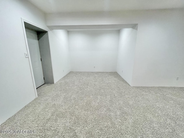 unfurnished room featuring light colored carpet