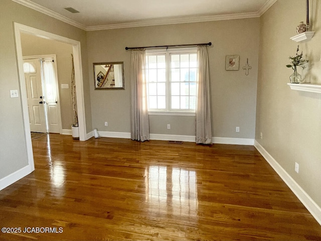 empty room with ornamental molding and dark hardwood / wood-style flooring