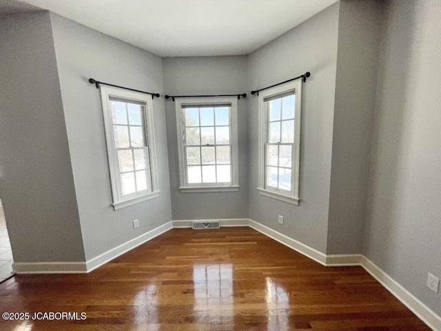 spare room featuring hardwood / wood-style floors