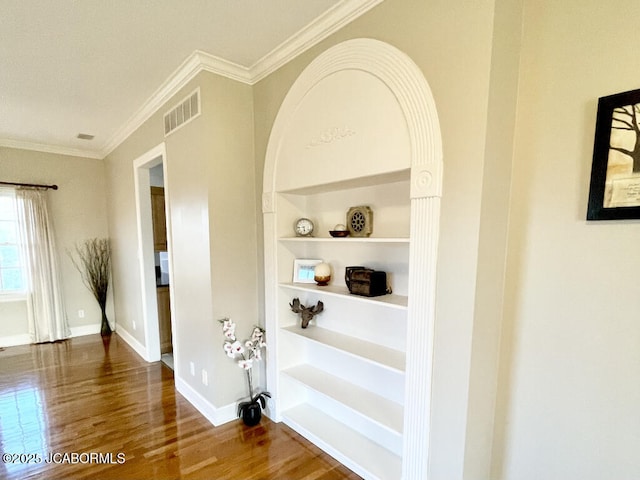 bathroom with hardwood / wood-style flooring, ornamental molding, and built in features