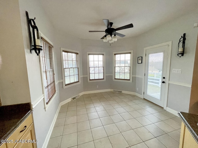 interior space featuring light tile patterned floors and ceiling fan