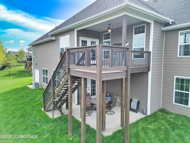back of house with a yard, stairway, fence, a shingled roof, and a patio