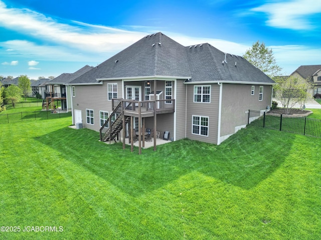 rear view of house with stairway, a wooden deck, a fenced backyard, and a patio area