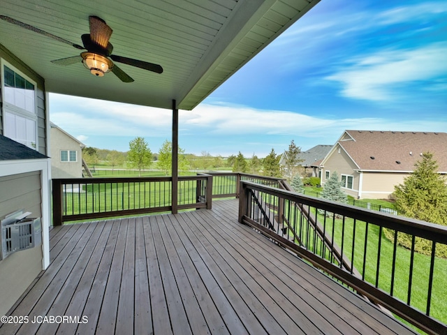 wooden deck with fence, a ceiling fan, a residential view, and a lawn