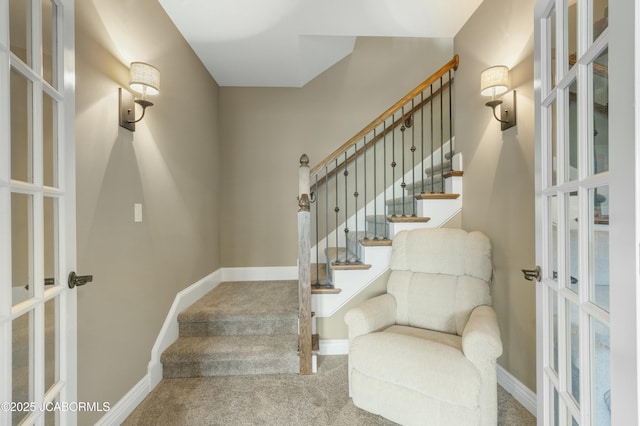 staircase with baseboards, french doors, and carpet floors