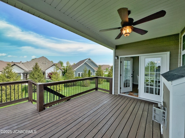 deck with a ceiling fan and a residential view