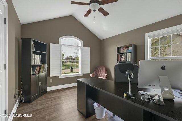 home office featuring dark wood-style floors, ceiling fan, vaulted ceiling, and a healthy amount of sunlight