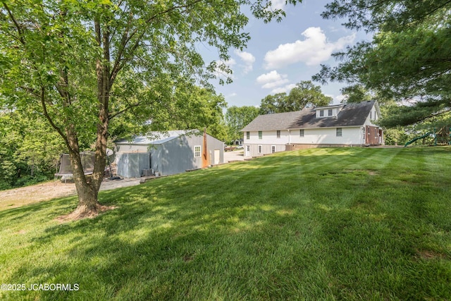7515 Rte M, Jefferson City, MO 65101 - view of green lawn with an outdoor structure and a trampoline