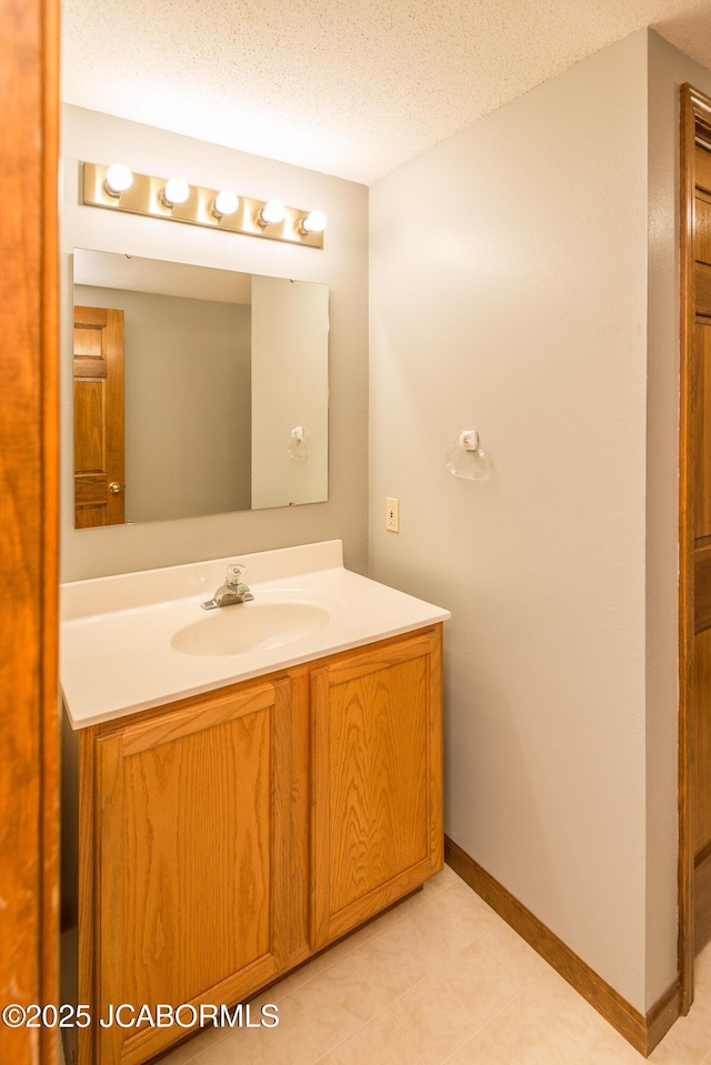 7515 Rte M, Jefferson City, MO 65101 - bathroom featuring vanity, a textured ceiling, and baseboards