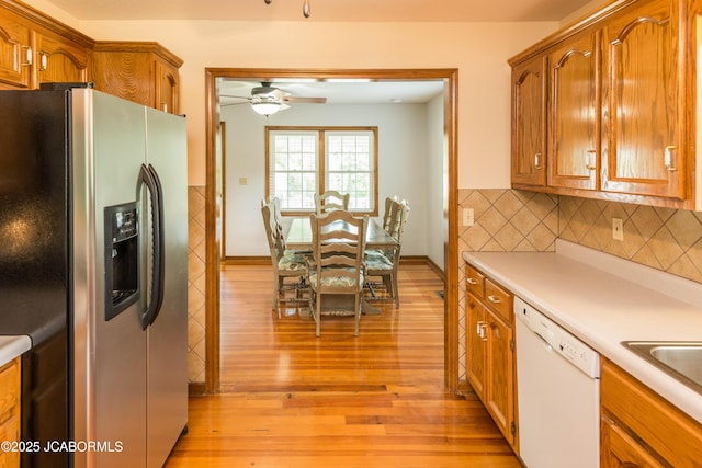 7515 Rte M, Jefferson City, MO 65101 - kitchen featuring stainless steel fridge with ice dispenser, dishwasher, light wood-style flooring, and light countertops