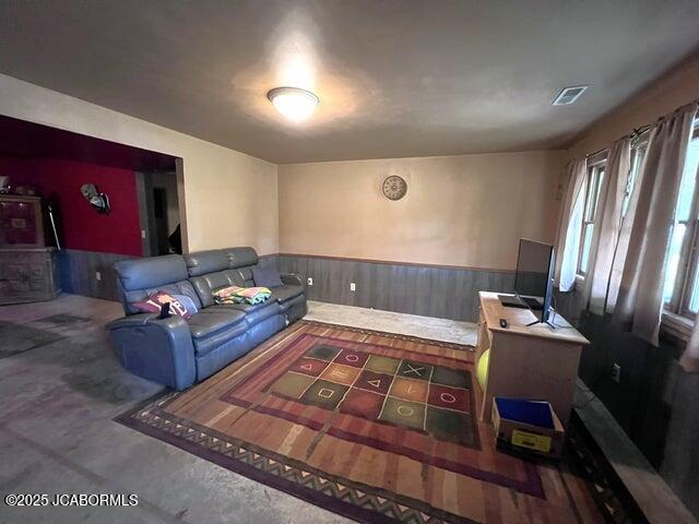 living room with a wainscoted wall