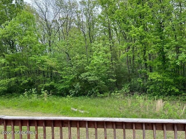 view of yard featuring a forest view