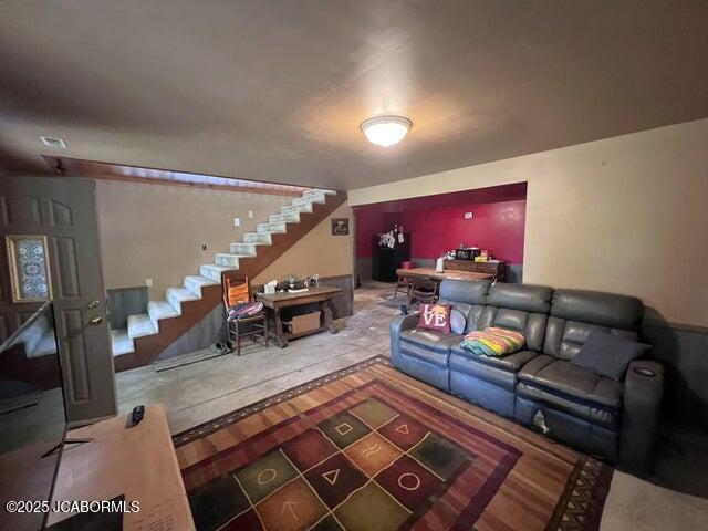 living area with stairway and wood finished floors