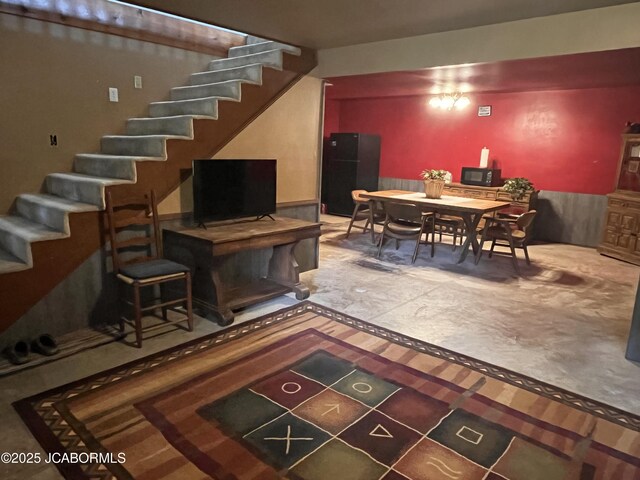 5888 State Rd E, Auxvasse, MO 65231 - living room with stairway, inlaid floor details, and a wainscoted wall