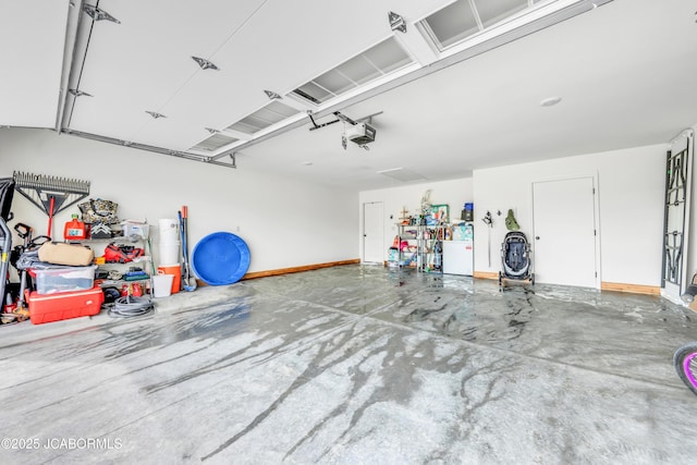 15250 General Dr, Ashland, MO 65010 - garage with baseboards and a garage door opener