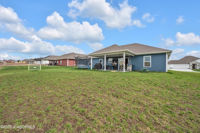 15250 General Dr, Ashland, MO 65010 - rear view of property featuring a trampoline, a yard, and a patio area