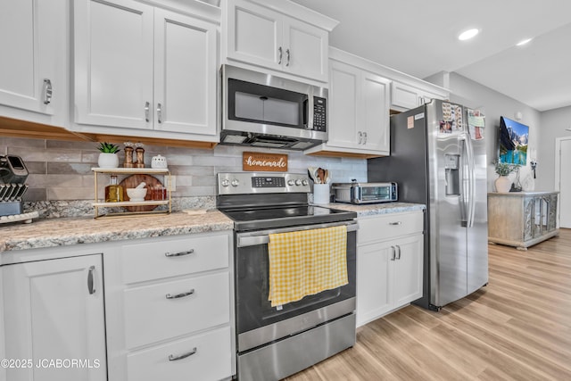 15250 General Dr, Ashland, MO 65010 - kitchen featuring light wood-style floors, stainless steel appliances, decorative backsplash, and white cabinets