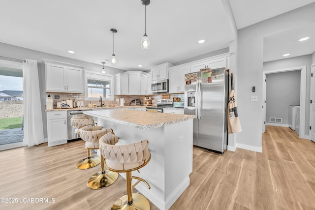 15250 General Dr, Ashland, MO 65010 - kitchen with appliances with stainless steel finishes, visible vents, and light wood-type flooring