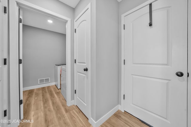 15250 General Dr, Ashland, MO 65010 - hallway with visible vents, baseboards, washer and clothes dryer, light wood finished floors, and recessed lighting