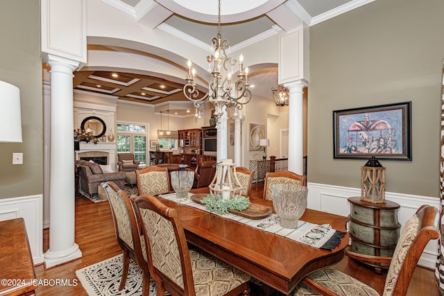 dining space with decorative columns, coffered ceiling, crown molding, beam ceiling, and a chandelier