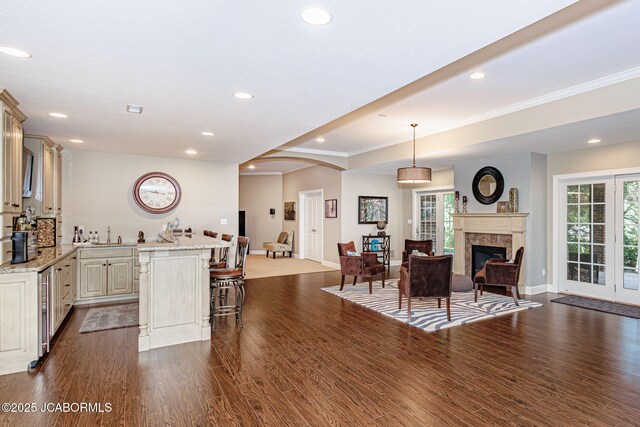 living room featuring wood-type flooring and ornamental molding