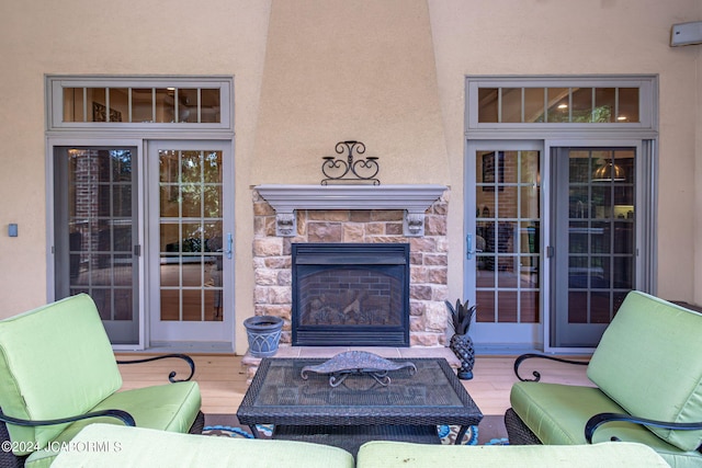 view of patio / terrace featuring an outdoor stone fireplace and a deck