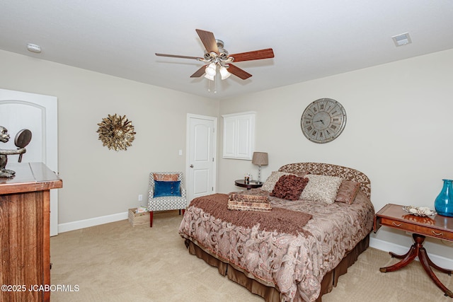 bedroom featuring visible vents, baseboards, ceiling fan, and light colored carpet