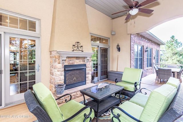 view of patio featuring an outdoor living space with a fireplace and ceiling fan