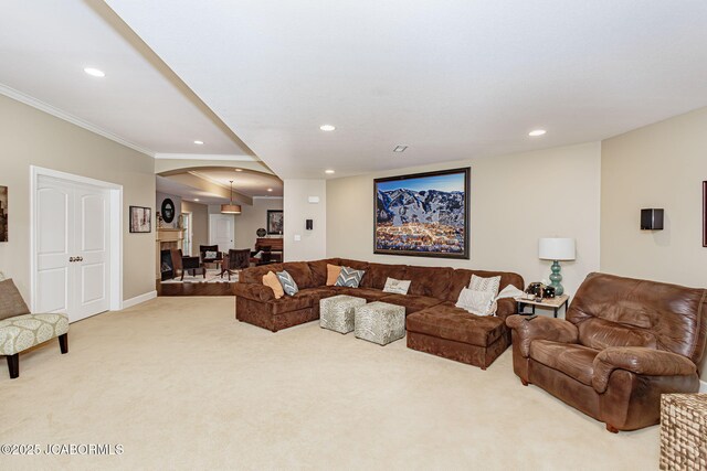 carpeted living room featuring ornamental molding