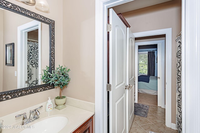 bathroom with tile patterned flooring and vanity