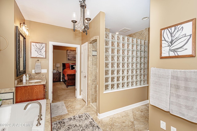 bathroom featuring a tile shower, vanity, and an inviting chandelier