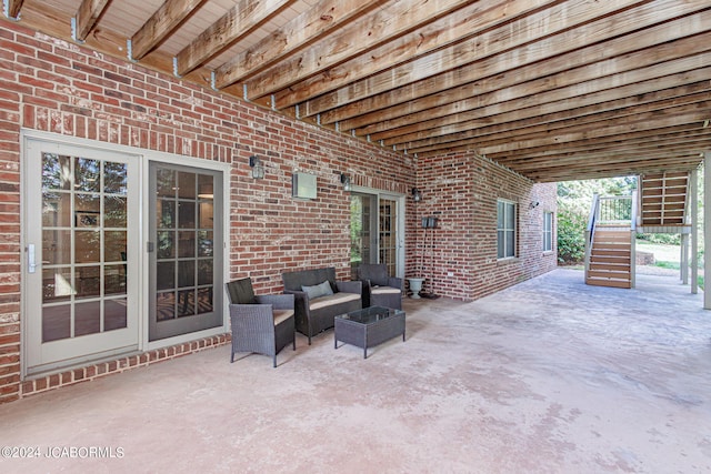 view of patio featuring an outdoor living space and stairway