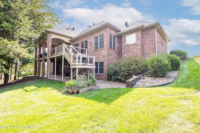 back of house with ceiling fan, a yard, and a deck