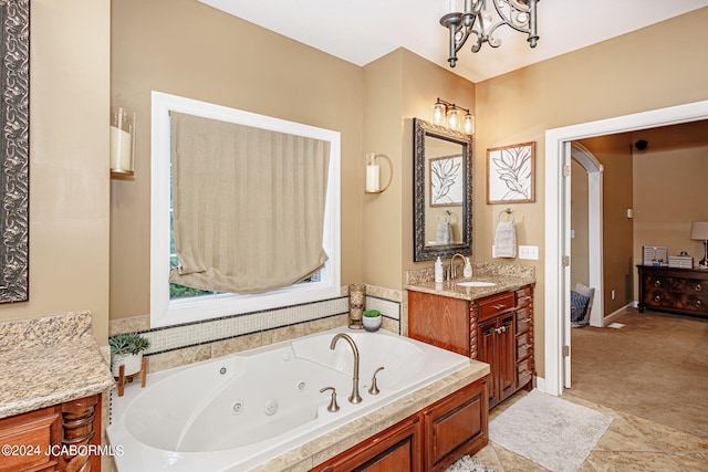 bathroom featuring a tub to relax in, tile patterned floors, vanity, and a chandelier