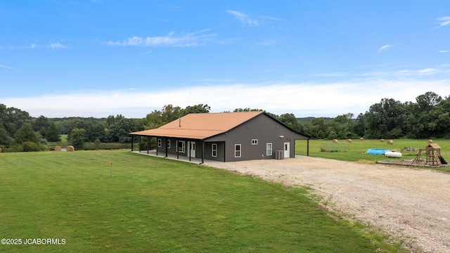 8596 County Rd 146, Williamsburg, MO 63388 - exterior space with metal roof, a patio area, central air condition unit, gravel driveway, and a yard