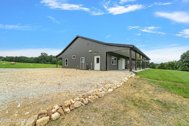 8596 County Rd 146, Williamsburg, MO 63388 - view of property exterior featuring a lawn, central AC unit, and gravel driveway