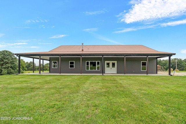 8596 County Rd 146, Williamsburg, MO 63388 - back of property featuring board and batten siding, a yard, a patio area, and metal roof