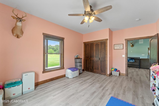 8596 County Rd 146, Williamsburg, MO 63388 - bedroom with ceiling fan, baseboards, wood finished floors, visible vents, and a closet