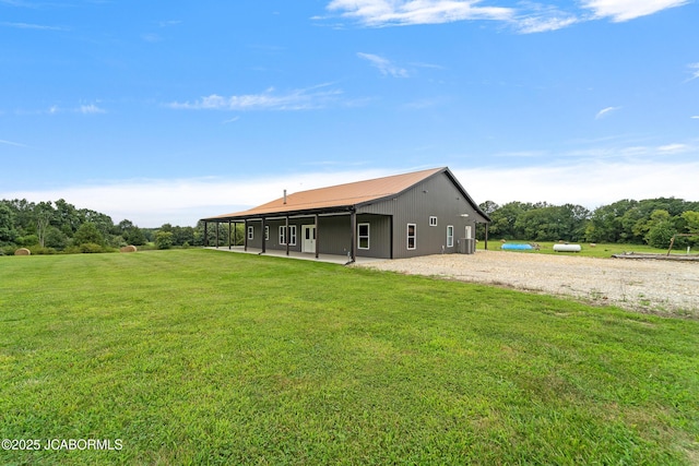 8596 County Rd 146, Williamsburg, MO 63388 - rear view of house featuring a lawn, a patio, and metal roof