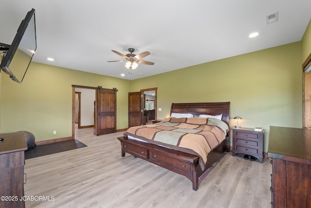 8596 County Rd 146, Williamsburg, MO 63388 - bedroom with visible vents, a barn door, wood finished floors, baseboards, and recessed lighting