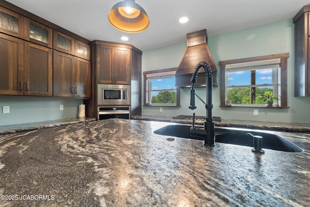 8596 County Rd 146, Williamsburg, MO 63388 - kitchen with a sink, dark stone counters, stainless steel appliances, recessed lighting, and glass insert cabinets