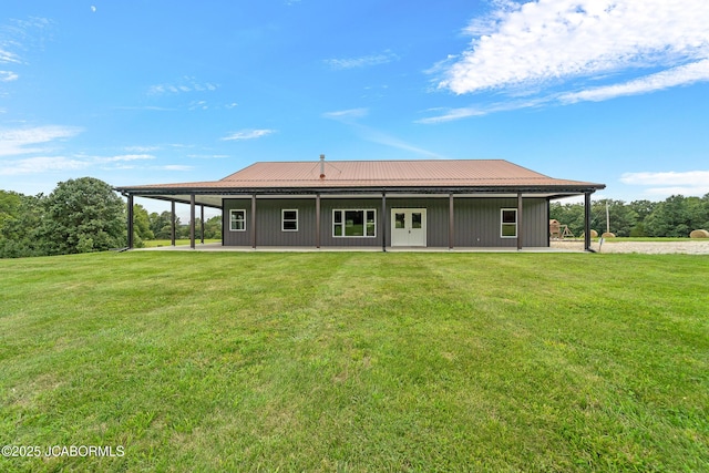 8596 County Rd 146, Williamsburg, MO 63388 - back of house with a lawn, metal roof, and a patio