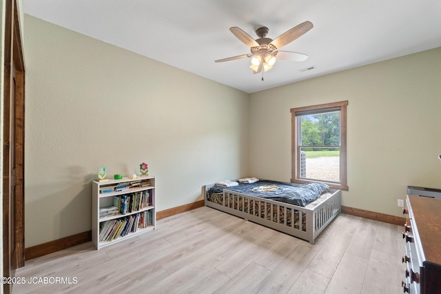 8596 County Rd 146, Williamsburg, MO 63388 - bedroom featuring baseboards, ceiling fan, light wood finished floors, and visible vents