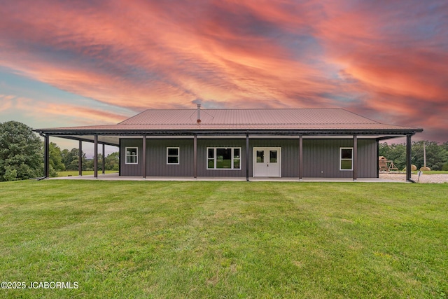 8596 County Rd 146, Williamsburg, MO 63388 - back of property featuring a lawn, board and batten siding, a patio area, and metal roof