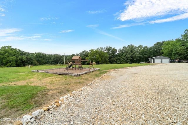 8596 County Rd 146, Williamsburg, MO 63388 - view of yard with an outbuilding, a playground, and a garage