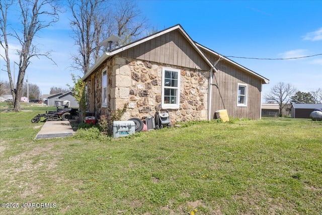 97 Stoddard Rd, Olean, MO 65064 - view of side of home featuring stone siding and a lawn