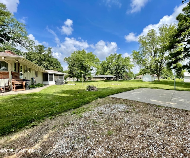 501 W Morgan St, Tipton, MO 65081 - view of green lawn featuring a sunroom and a patio area